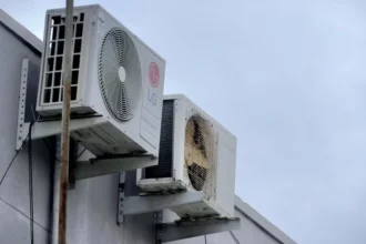 Outdoor air conditioning unit attached to building wall