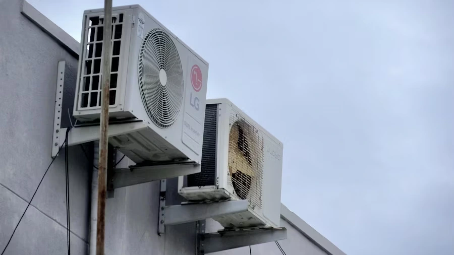 Outdoor air conditioning unit attached to building wall