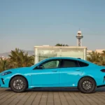 BMW i2 electric sedan parked on city street, showcasing its sleek design.