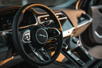 Vintage Jaguar steering wheel with logo on the center.