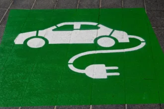 Eco-friendly green and white electric car and sustainability symbol sign