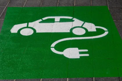 Eco-friendly green and white electric car and sustainability symbol sign