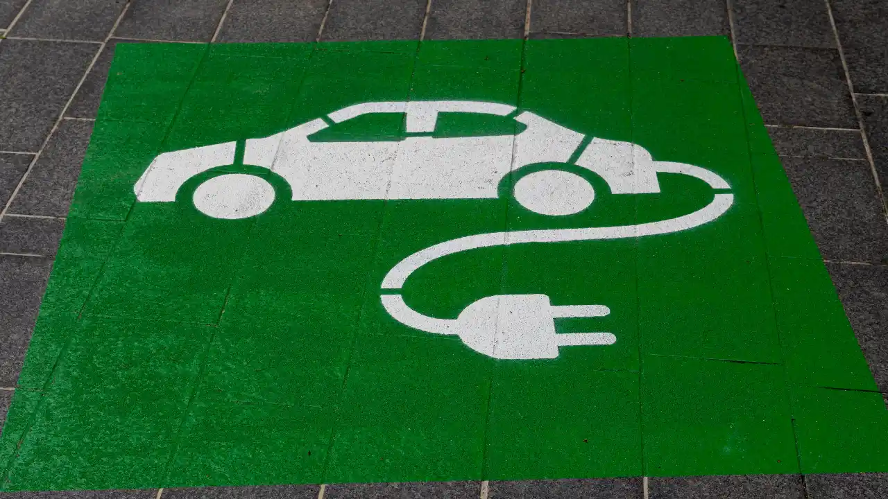 Eco-friendly green and white electric car and sustainability symbol sign