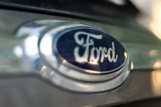 Ford logo on a grey car bumper showcasing branding and design.
