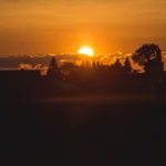 Sunset scene during golden hour with warm, glowing sky.