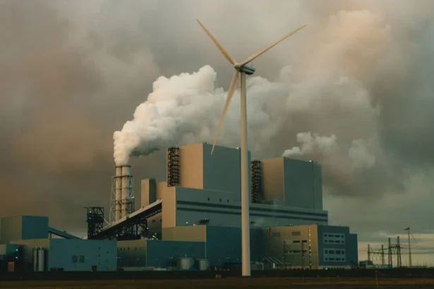 Factory with tall chimneys releasing smoke into the sky