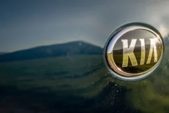 Kia logo on a modern car emphasizing brand identity.