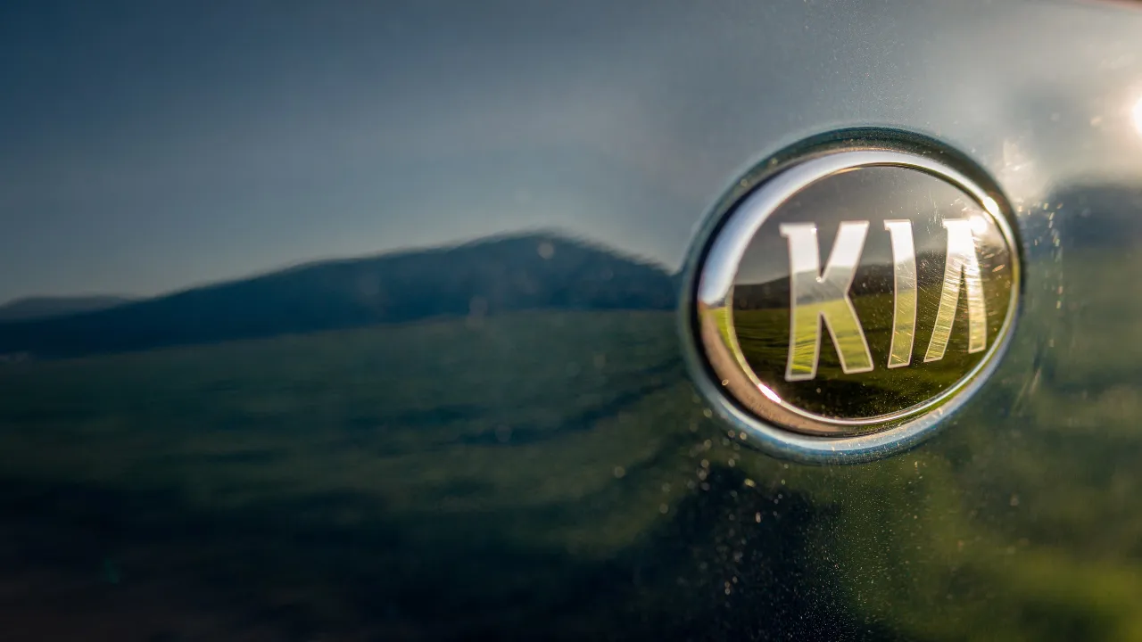 Kia logo on a modern car emphasizing brand identity.
