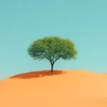 Green tree alone on golden sand dune under blue sky in desert