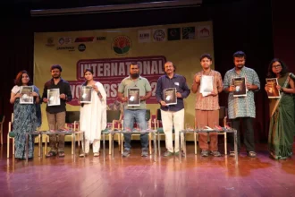 Workers from South Asia protesting for climate justice during Labour Day with signs and banners.