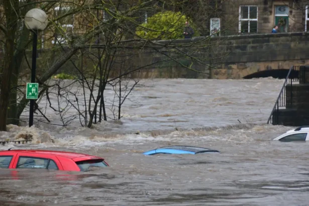 Car submerged in floodwaters during heavy flooding event.