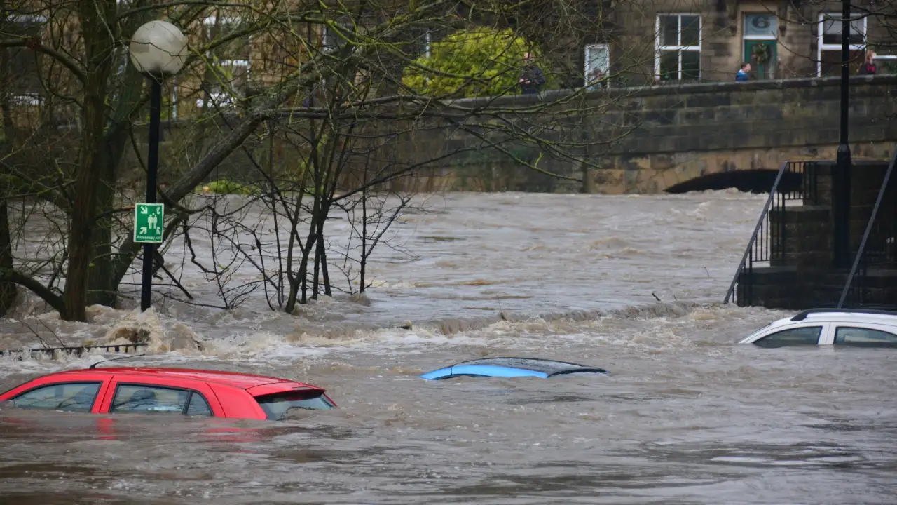 Car submerged in floodwaters during heavy flooding event.