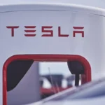 Close-up of a modern white and red Tesla gas station.