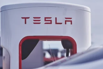Close-up of a modern white and red Tesla gas station.